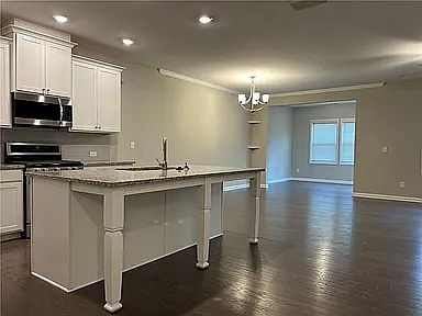 Large spacious kitchen with view of breakfast area and sunroom
