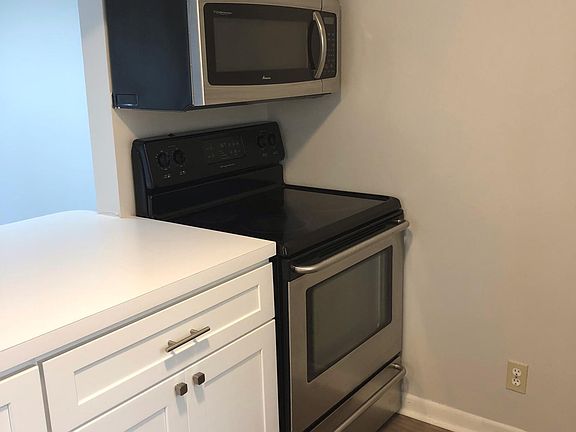 Remodeled kitchen quartz countertops. ice maker, stainless steel sink and dishwasher, stove and microwave