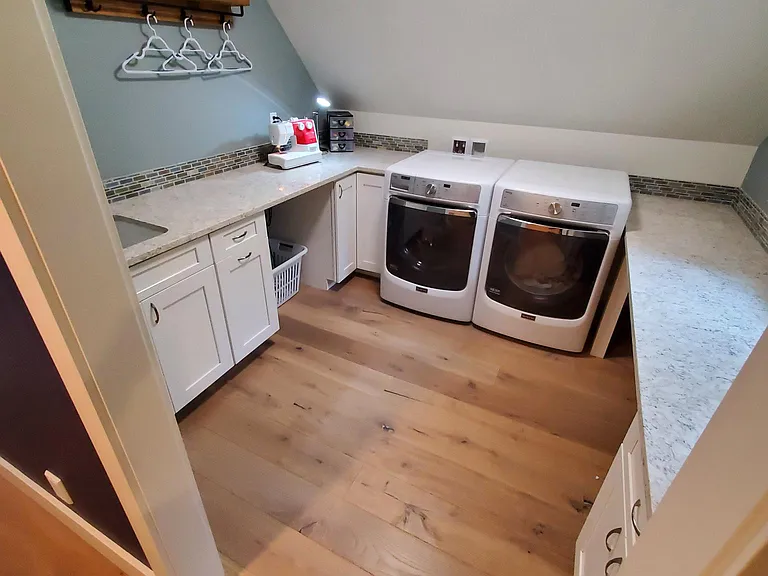 Upstairs laundry room with quartz countertops keeps the laundry off the dining room table and sofas.