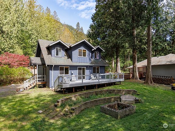 Amazing yard and deck, surrounded by beautiful Evergreens.  Enjoy warm summer nights around your fire pit.>