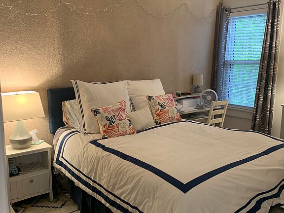 Lovely queen bed with desk & nightstand in master bedroom