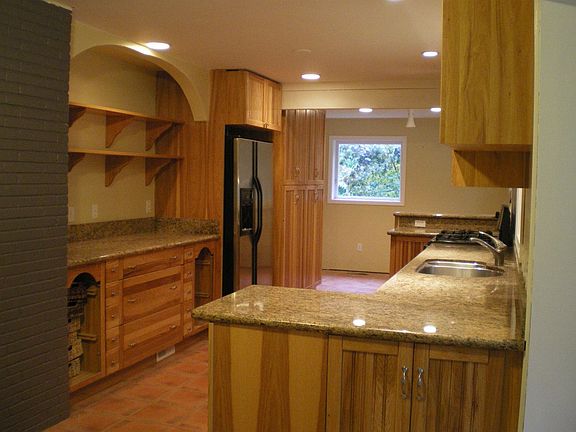 Large galley kitchen layout boasts a breakfast bar and dining nook.