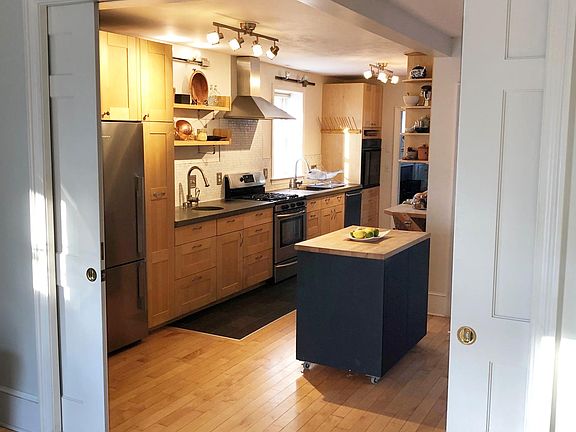 View into open kitchen from family room with pocket doors partially closed.
