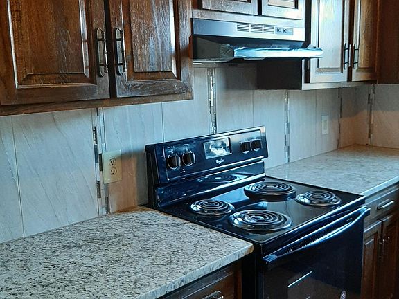 Kitchen with new granite and tile backsplash.