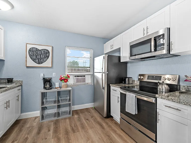 New Stainless Steel Appliances, Granite Countertops, and White Cabinets