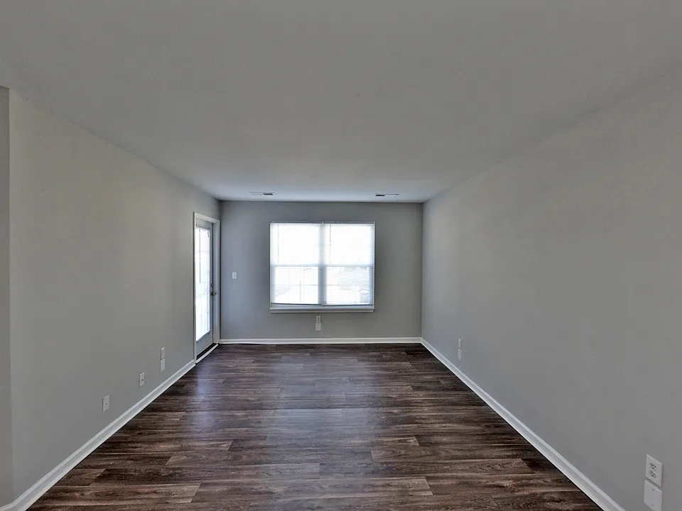 Spacious living room with hardwood-style flooring