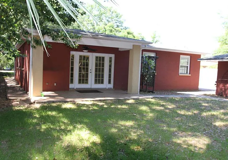 Fenced in backyard with doggy door