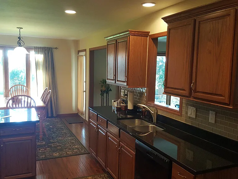 Bright updated kitchen with newer appliances and open dining area.