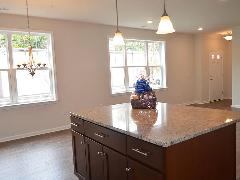 Downstairs with the view of the island in the kitchen, front door, and the Cleveland Ave.