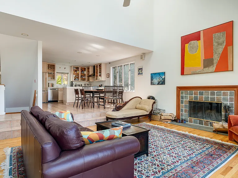Living room with wood-burning fireplace.