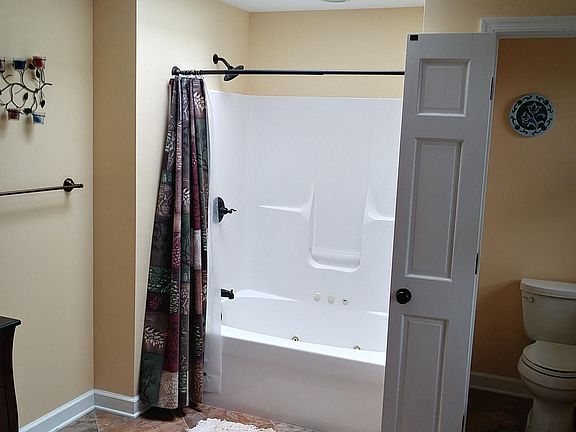 master bathroom, with 2 granite sinks, jetted bathtub/shower, and water closet