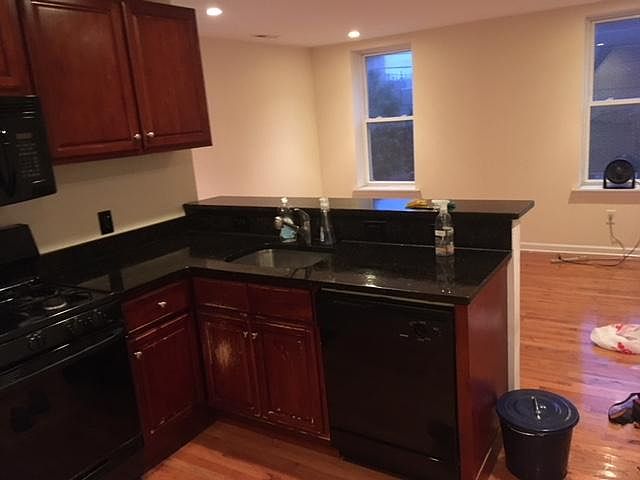 Kitchen with counter and other side living room