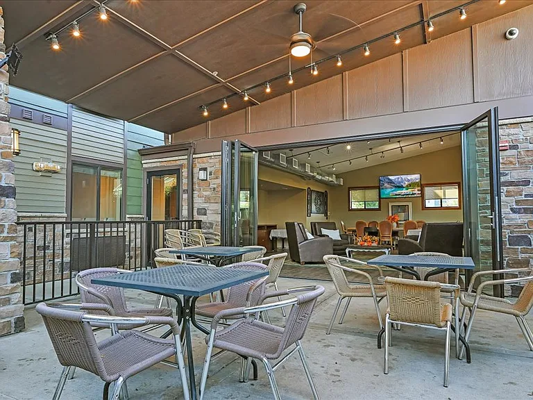 Outdoor patio with fire table and heat lamps for year round use.
