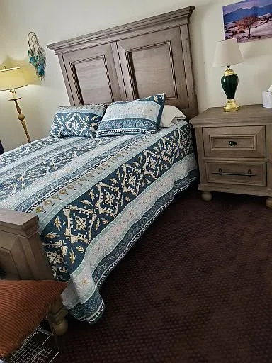 Furnished bedroom suite, side table, corner lamp, side table lamp, chair