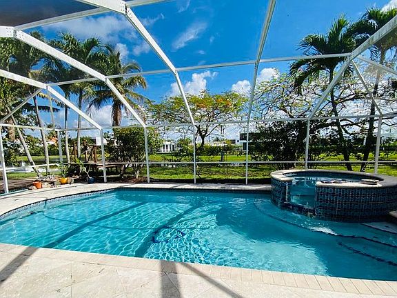 Pool, jacuzzi and lake view.