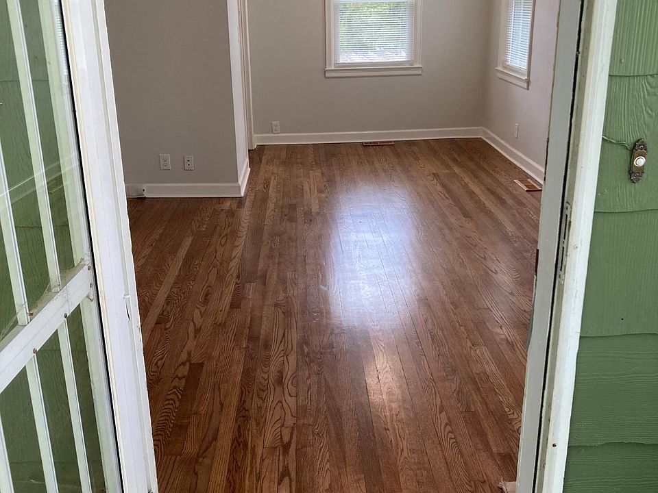 Front door leading into living room with brand new refinished hardwood floors.