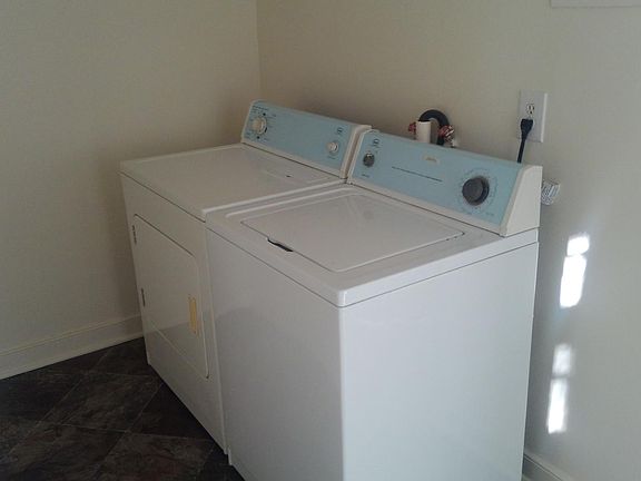 Laundry area off kitchen with full size washer and dryer and