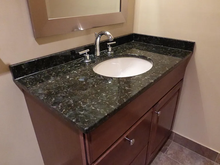The bathroom includes a designer selected marble vanity top.