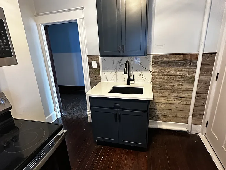 New kitchen cabinets, sink with quartz countertop & backsplash & shiplap decorative siding
