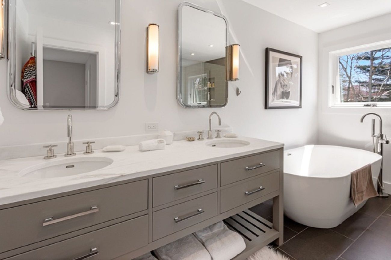 Primary bathroom one with soaking tub, shower stall, double vanity granite top and tiled floor