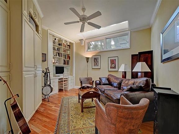 Formal living area has plenty of built in book cases and an abundance of storage