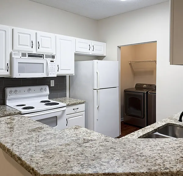 Kitchen view from the breakfast bar. Note the laundry room off the kitchen.