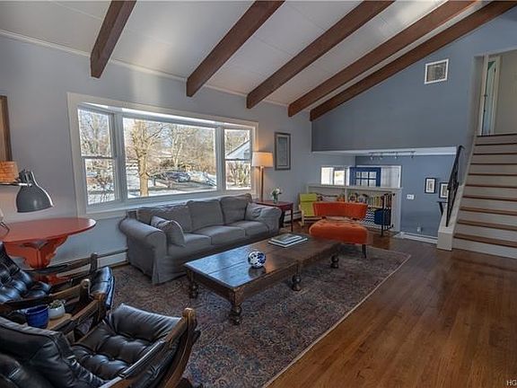 Natural light pours into the living room .