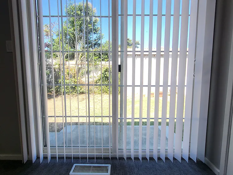 Bedroom #1 with sliding door to private back yard.