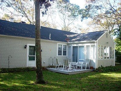 Rear view of the house shows the wood deck for outdoor relaxation and grilling. It is accessed through the family room sliders.