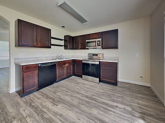 Spacious kitchen with dark woo