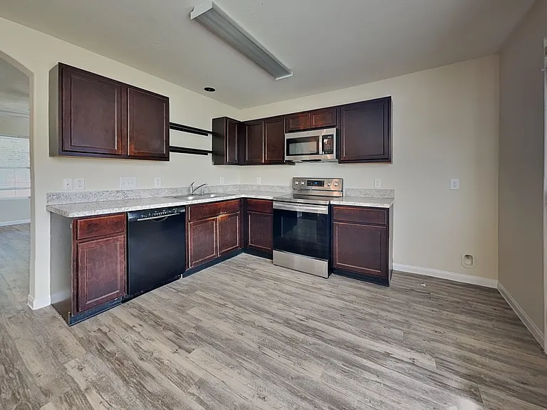 Spacious kitchen with dark woo