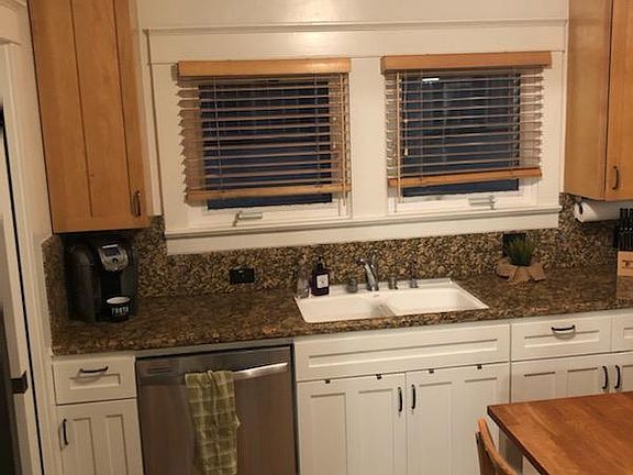 Modern kitchen with built-in appliances, granite countertop.