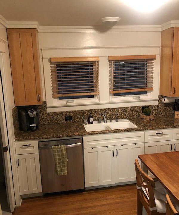 Modern kitchen with built-in appliances, granite countertop.