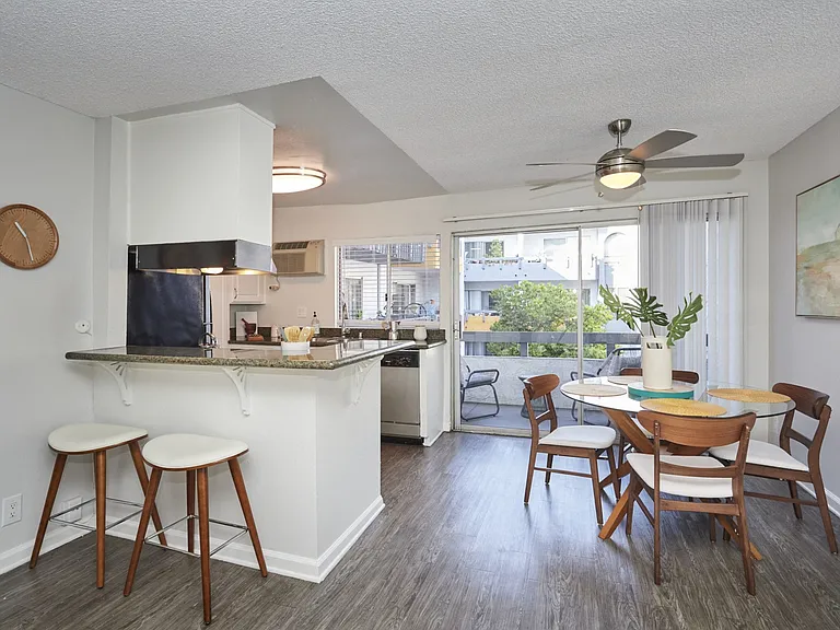 Dining Area and Kitchen Next to Balcony