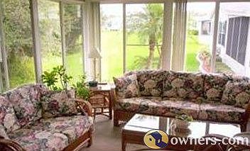 Glassed in lanai with wooded view