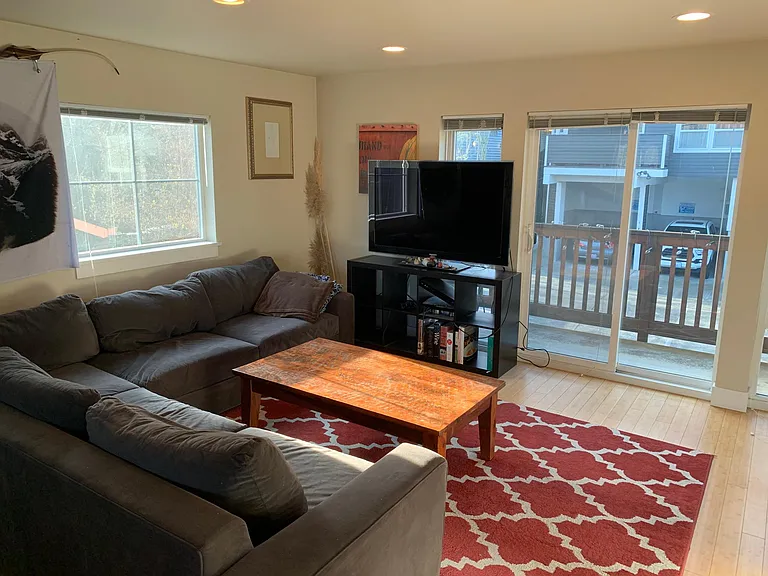 Living area and sliding glass door to balcony.