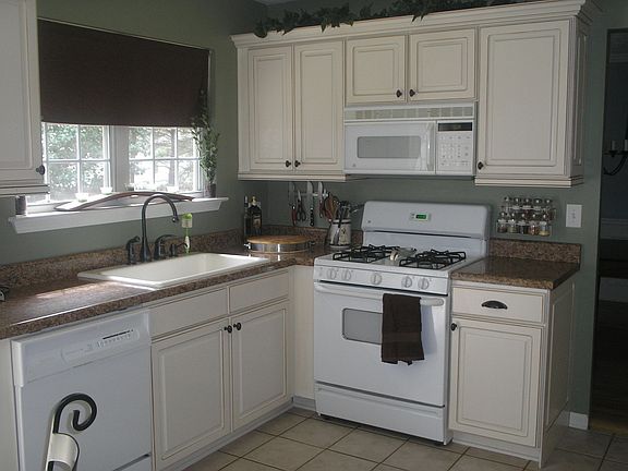 Custom cabinetry with 4" molding, bronze hardware and task lighting