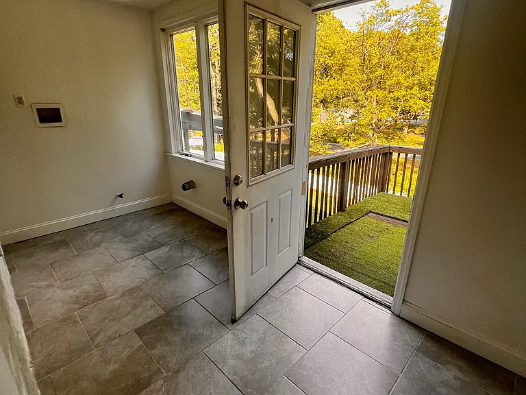 Enclosed porch that leads to the deck