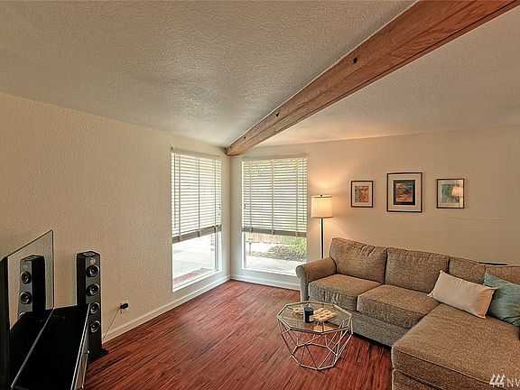 Newer windows, paint and flooring make this ground floor home a rare find!