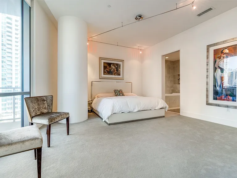 Bedroom with multiple windows and carpet floors