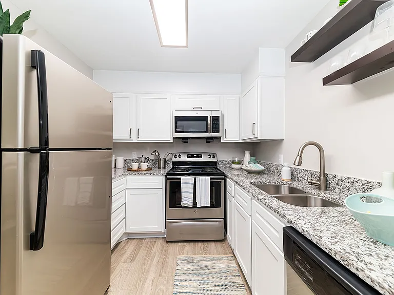 Kitchen with granite counters, stainless appliances, and modern cabinetry