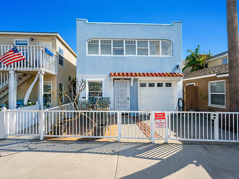 Front exterior with gated entry and charming beach style