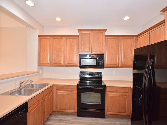 Kitchen with lots of cabinet space and black appliances