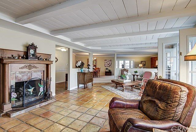 Bonus room with spanish tile flooring, fireplace and french doors to back patio.