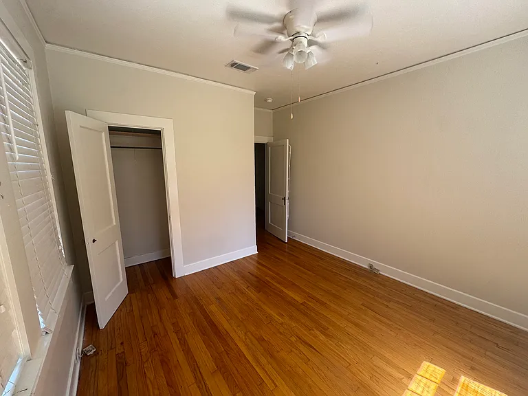 Bedroom 3 with private closet and windows to backyard and side driveway area of the home
