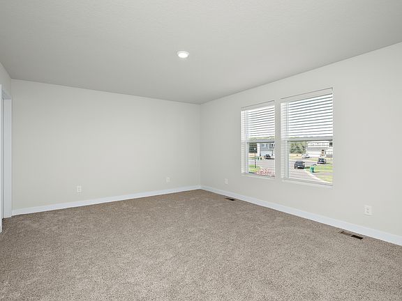 The master bedroom is spacious with a large window.