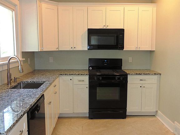 Brand-new kitchen has granite counter tops and all new appliances, including built-in microwave and dishwasher!