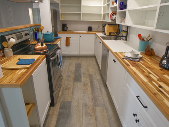 Kitchen counters are oiled butcher block and there's lots of open shelving for your pantry and personal items
