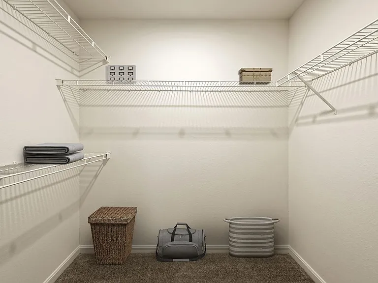 Walk in closet with linen rack and storage space