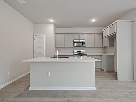 Kitchen in the Willow home plan by Trophy Signature Homes - REPRESENTATIVE PHOTO